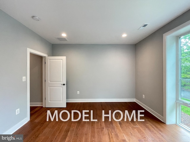 unfurnished room featuring hardwood / wood-style floors