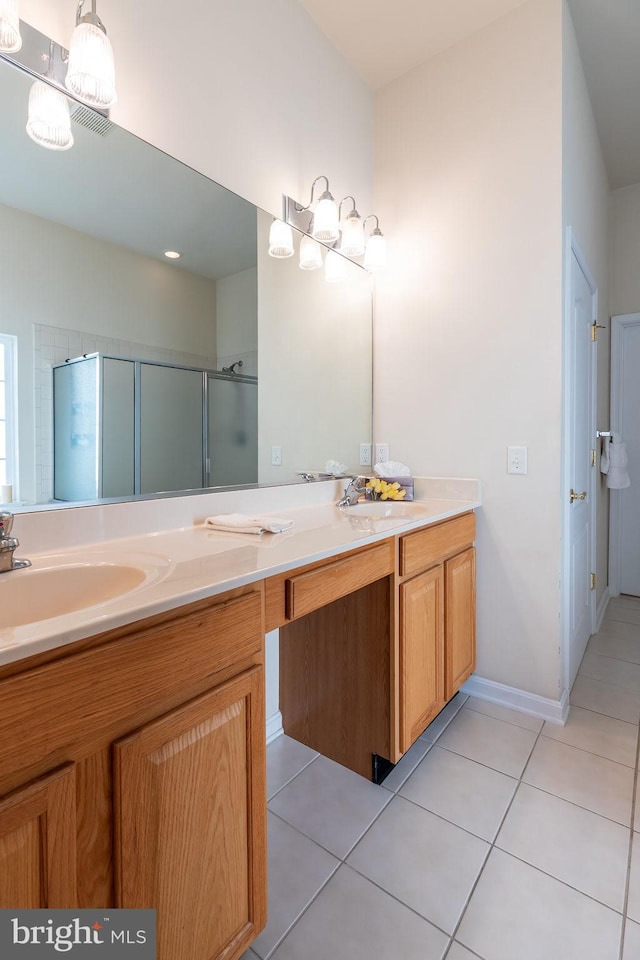 bathroom with vanity, tile patterned floors, and a shower with door