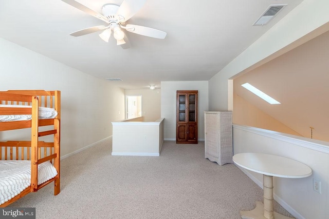 bathroom featuring ceiling fan and a skylight