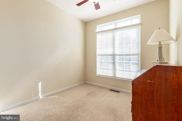 unfurnished room featuring ceiling fan and light carpet