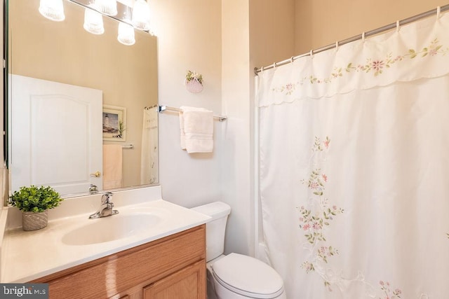 bathroom with vanity, toilet, and a shower with shower curtain