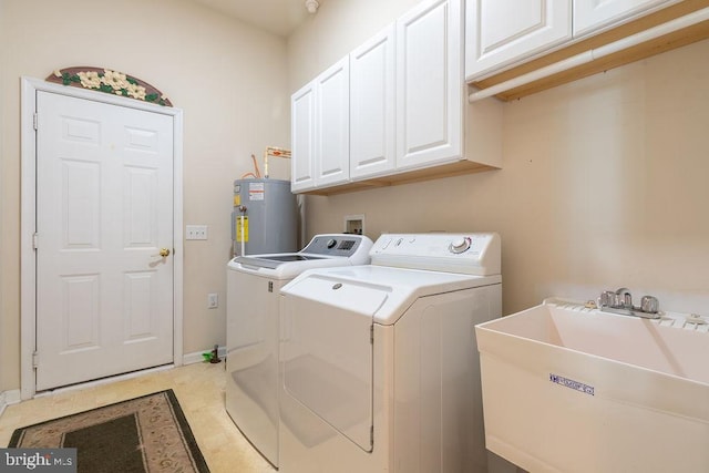 laundry room featuring cabinets, water heater, sink, and washer and dryer