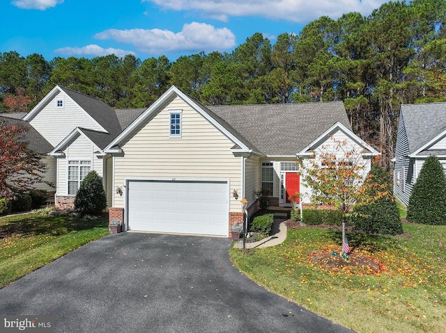 view of front of home with a garage and a front lawn