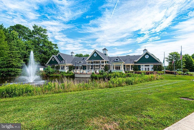 exterior space with a lawn and a water view