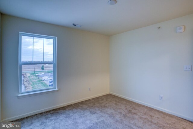 empty room featuring light colored carpet