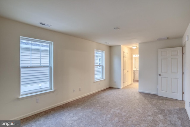 5003 E Pebble Ln Unit J, Milford, DE 19963 - unfurnished bedroom with baseboards, carpet flooring, and connected bathroom