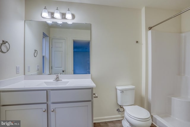 5003 E Pebble Ln Unit J, Milford, DE 19963 - bathroom with a shower, toilet, vanity, baseboards, and wood finished floors