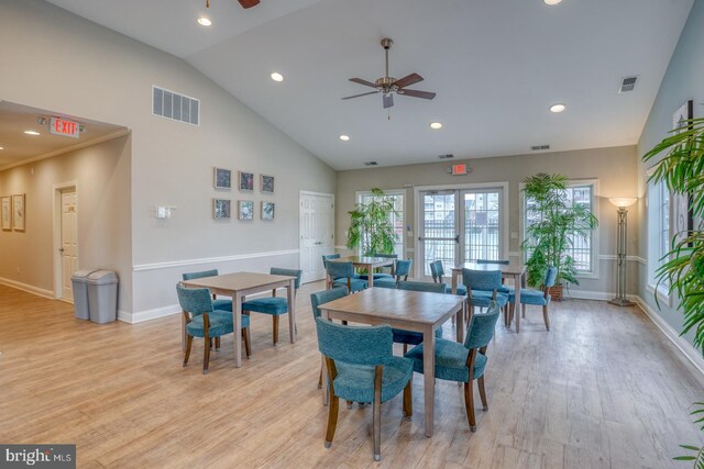 dining area featuring high vaulted ceiling, light hardwood / wood-style floors, french doors, and ceiling fan