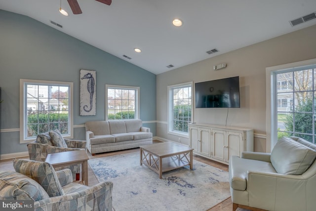 living room featuring light wood-type flooring, vaulted ceiling, and ceiling fan