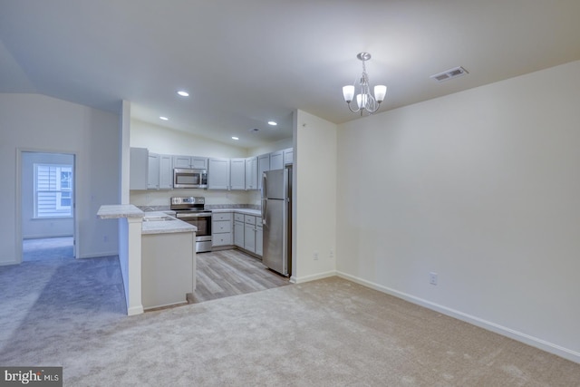 5003 E Pebble Ln Unit J, Milford, DE 19963 - kitchen featuring stainless steel appliances, light colored carpet, lofted ceiling, baseboards, and recessed lighting