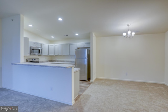 5003 E Pebble Ln Unit J, Milford, DE 19963 - kitchen with appliances with stainless steel finishes, light carpet, recessed lighting, and a peninsula