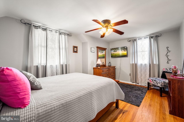 bedroom featuring ceiling fan, lofted ceiling, and wood-type flooring