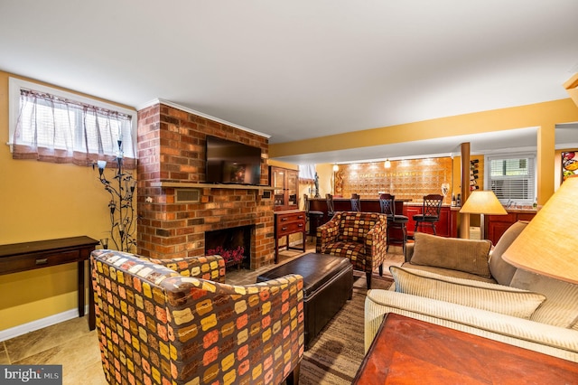 living room with brick wall and a brick fireplace