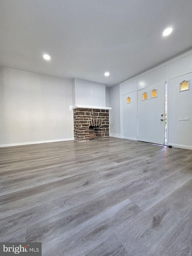 unfurnished living room with hardwood / wood-style flooring and a fireplace