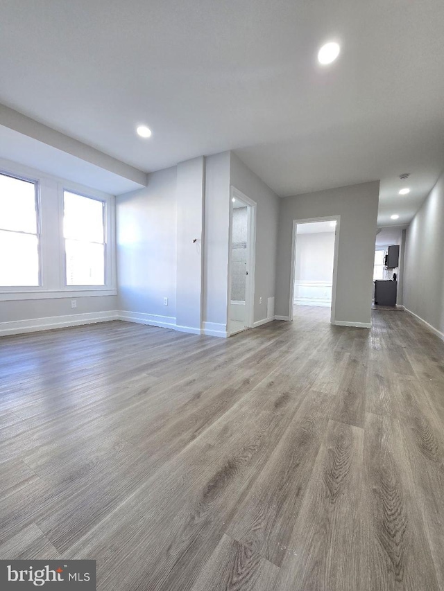 unfurnished living room featuring hardwood / wood-style floors