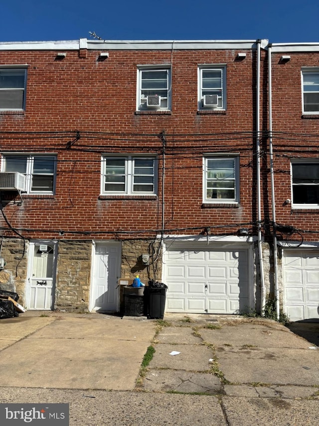 back of property featuring a garage