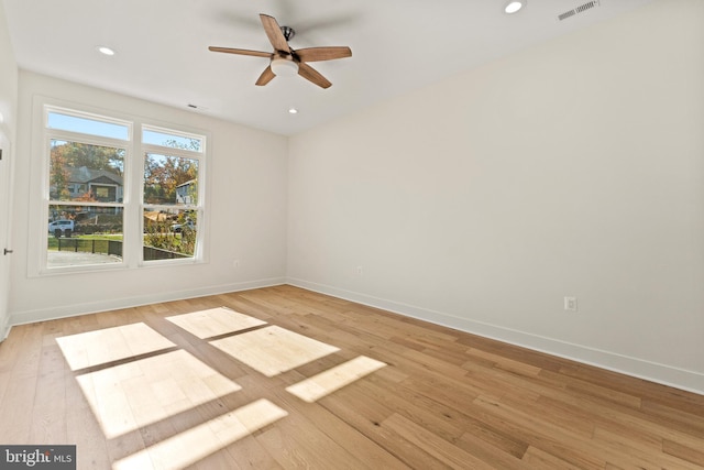 unfurnished room with ceiling fan and light wood-type flooring