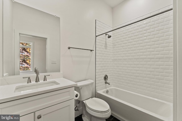 full bathroom with tiled shower / bath, vanity, and toilet