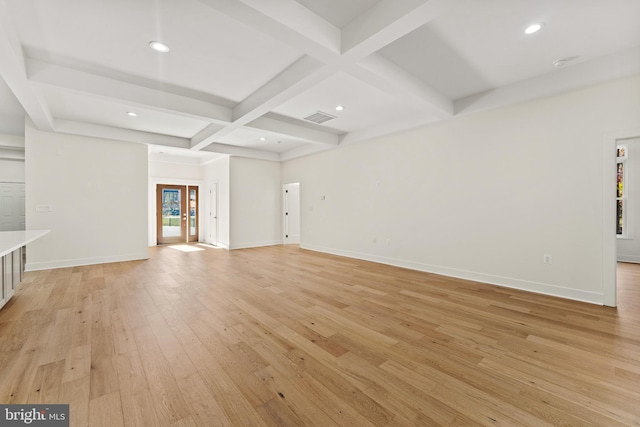 unfurnished living room featuring french doors, coffered ceiling, beam ceiling, and light hardwood / wood-style flooring