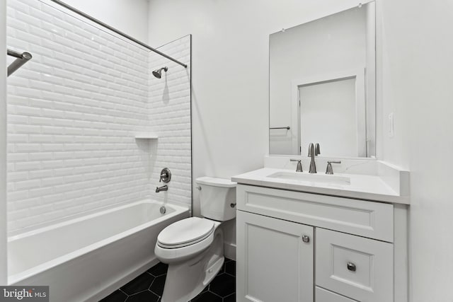 full bathroom with vanity, tile patterned floors, toilet, and tiled shower / bath