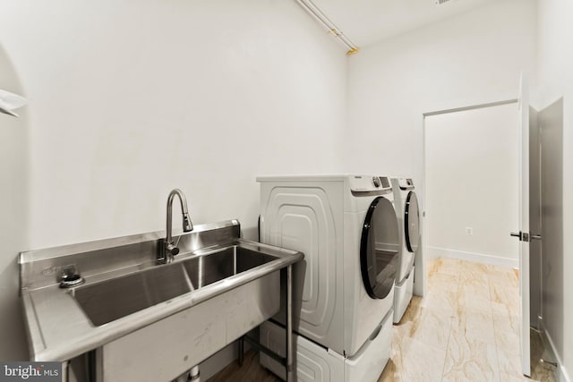 washroom featuring washing machine and clothes dryer and sink