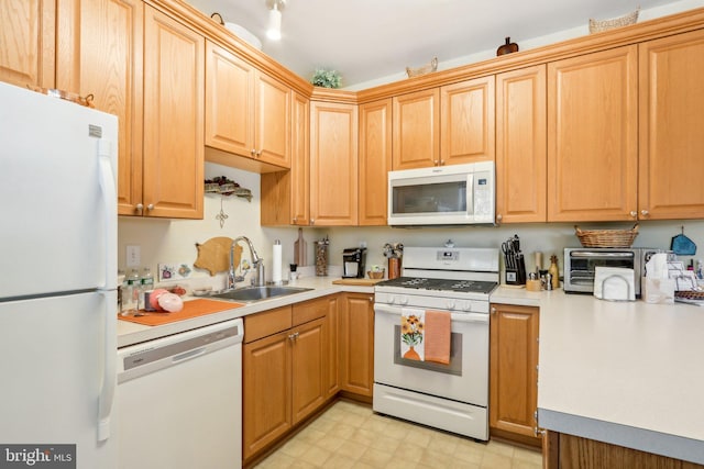 kitchen featuring white appliances and sink