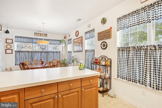 kitchen with a wealth of natural light and pendant lighting