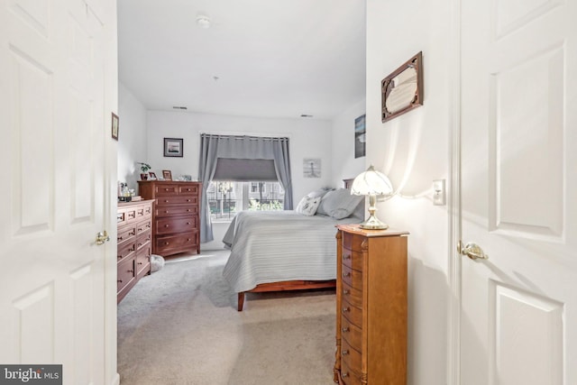 bedroom featuring light colored carpet