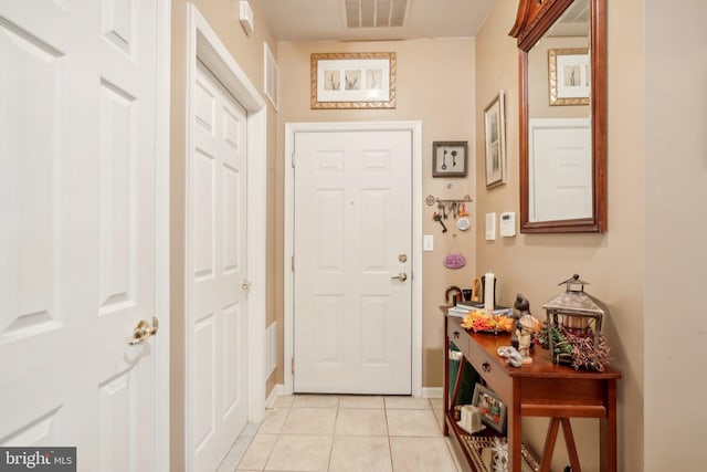 entryway with light tile patterned floors