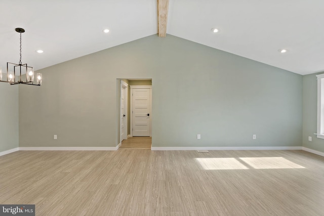 empty room featuring lofted ceiling with beams, light hardwood / wood-style floors, and an inviting chandelier