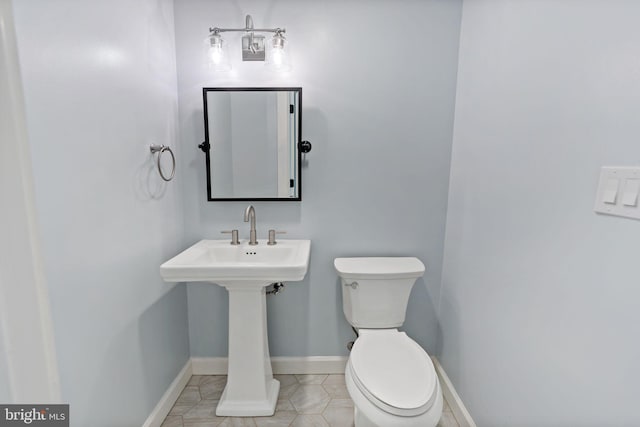 bathroom with tile patterned flooring and toilet