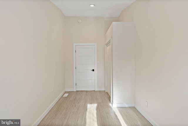 corridor with light wood-type flooring