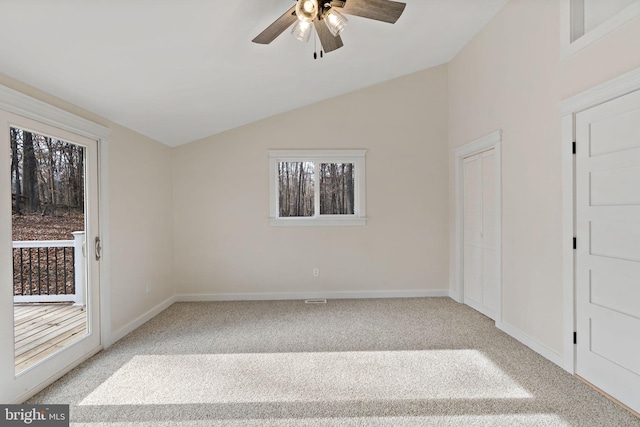 unfurnished room featuring light colored carpet, ceiling fan, and lofted ceiling