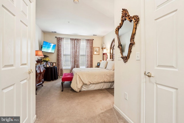 bedroom featuring light carpet