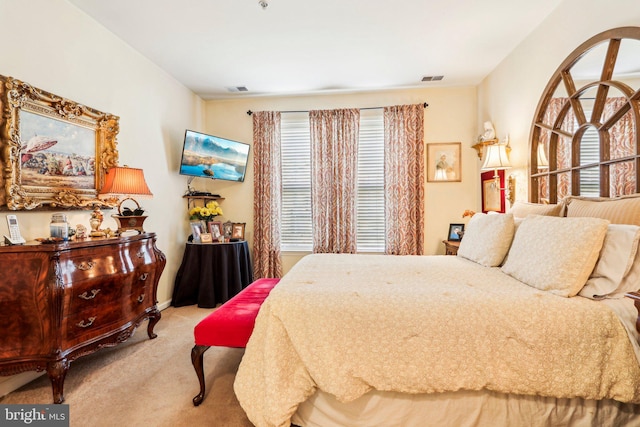 bedroom featuring light colored carpet