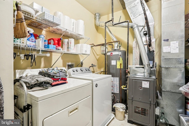 washroom featuring gas water heater and washing machine and clothes dryer