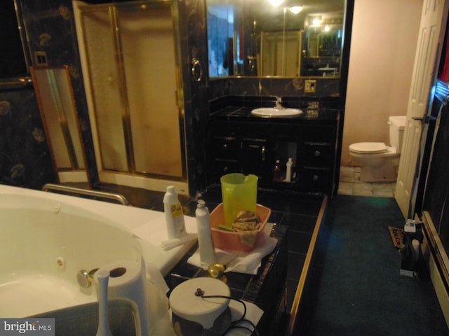 bathroom with tile patterned flooring, vanity, and toilet