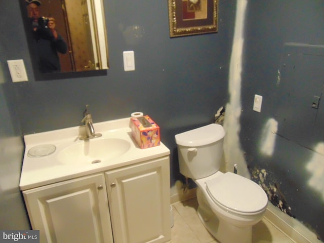 bathroom featuring tile patterned flooring, vanity, and toilet