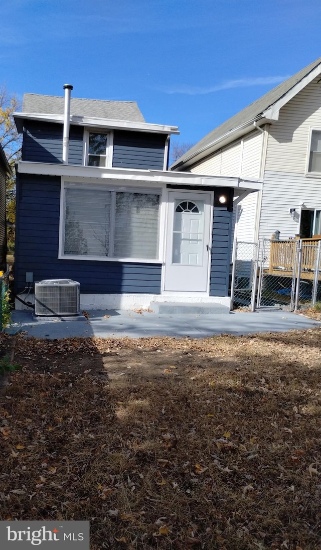 rear view of house featuring cooling unit