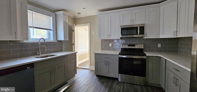 kitchen with white cabinets, appliances with stainless steel finishes, and sink