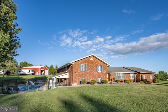 rear view of property with a yard