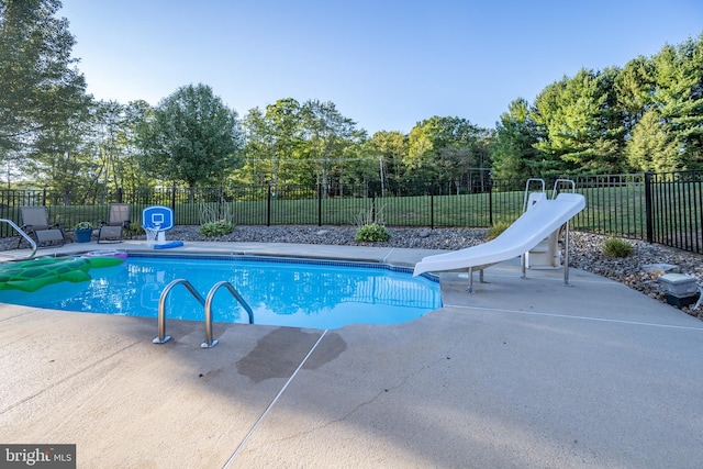 view of pool featuring a patio area and a water slide