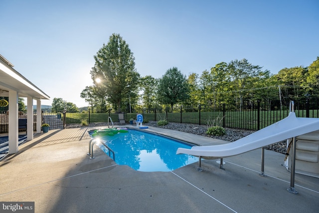 view of pool featuring a water slide and a patio area