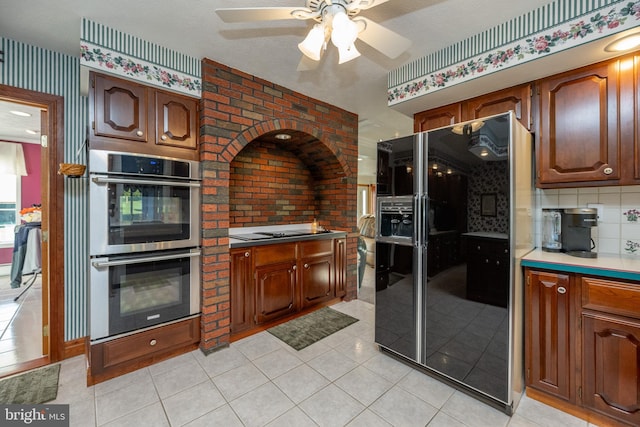 kitchen featuring black appliances, a textured ceiling, light tile patterned floors, decorative backsplash, and ceiling fan