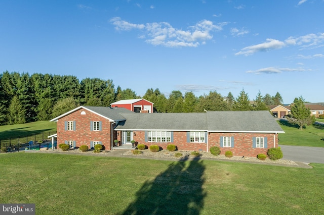 view of front facade featuring a carport and a front yard