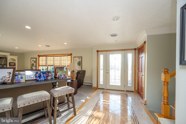 entryway featuring baseboard heating, light tile patterned floors, and crown molding