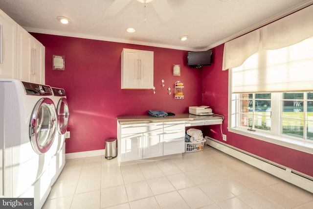 washroom with cabinets, baseboard heating, washer and dryer, and crown molding