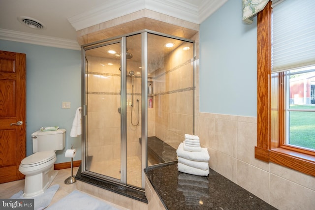 bathroom with walk in shower, ornamental molding, tile patterned floors, toilet, and tile walls