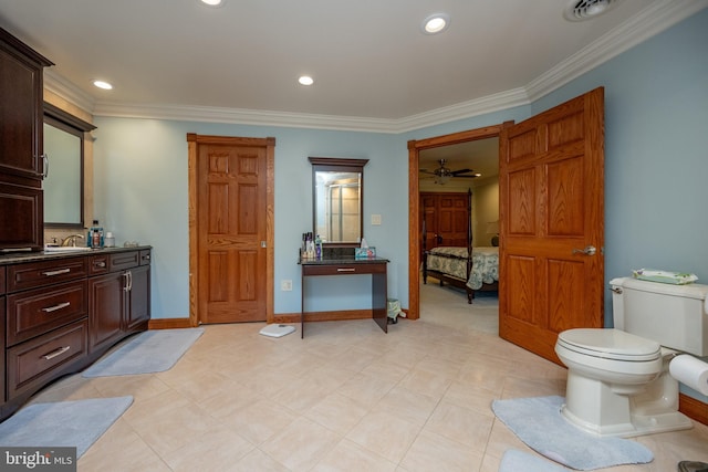 bathroom with ceiling fan, vanity, toilet, and ornamental molding