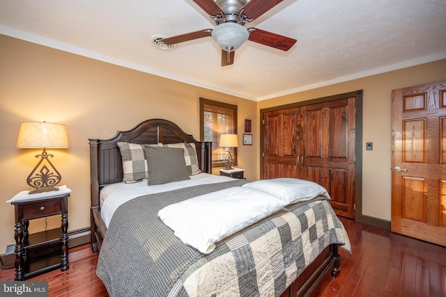 bedroom with dark hardwood / wood-style flooring, ornamental molding, ceiling fan, and a baseboard radiator